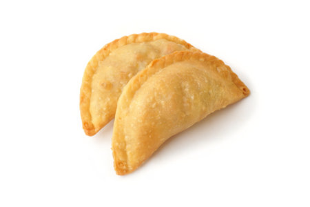 Curry puff or Fried Pastel is a popular dry cake in Indonesia. Fried pastries filled with potatoes and carrots isolated on a white backgroundの写真素材