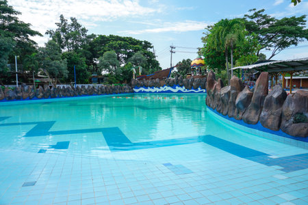 The swimming pool is equipped with various water rides, one of which is an artificial wave rideの写真素材