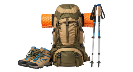 A large khaki and olive green hiking backpack is centered with an orange sleeping pad strapped to it. To the left are a pair of brown and blue hiking boots. To the right are a pair of blue and silver trekking poles. The items are arranged on a white background.の素材