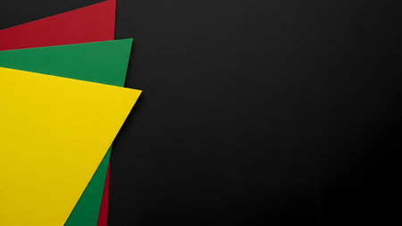 A minimalist abstract composition featuring overlapping geometric shapes in vibrant red, green, and yellow positioned on the left side against a solid black background. The shapes are arranged in a layered fashion, creating a sense of depth and visual interest. The clean lines and bold colors offer a striking contrast.の写真素材