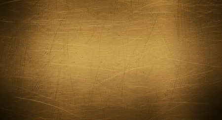 A detailed close-up of a brushed gold metal surface. The texture is characterized by numerous fine...