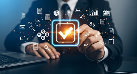 A person's hands are shown interacting with a glowing digital checkmark icon, signifying completion or approval. The interface is surrounded by various business and finance-related icons, including currency symbols (Euro, Yen, Dollar), a calculator, charts, documents, and magnifying glass. The scene suggests a focus on financial tasks, tax-related processes, or business compliance.の写真素材