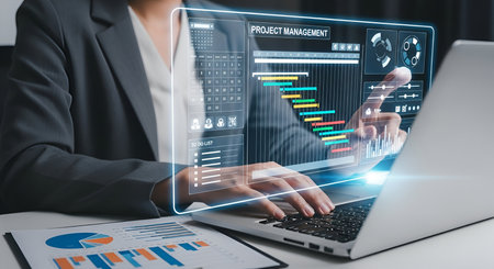 A person's hands interact with a holographic display showcasing a project management dashboard. The interface features a Gantt chart, a calendar, to-do lists, and various charts and graphs, illustrating project planning and progress tracking.の写真素材