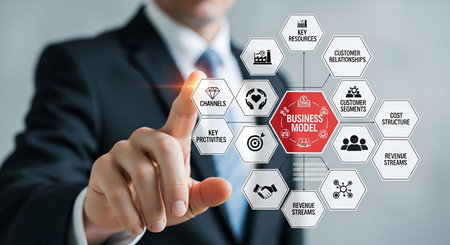 A businessman in a suit and tie points his finger towards a digital infographic displaying a business model canvas. The diagram is composed of interconnected hexagonal icons representing various business components such as customer segments, revenue streams, cost structure, key resources, and channels. The central icon highlights "BUSINESS MODEL" in red.の写真素材