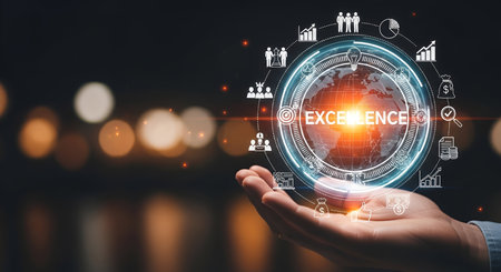 A human hand is cupped upwards, holding a glowing digital representation of the Earth. A circular interface surrounds the globe, displaying various business and finance icons such as graphs, people, money bags, and charts. The word "EXCELLENCE" is prominently displayed in the center of the globe. The background is dark and blurred with soft bokeh lights, suggesting a nighttime or indoor setting.の写真素材