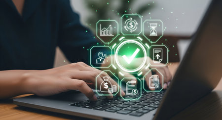A person's hands are typing on a laptop keyboard. A digital interface hovers above the keyboard, displaying a central green checkmark within a circle, surrounded by hexagonal icons representing business processes like finance, documents, time management, and growth.の写真素材