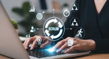 A person's hands are typing on a laptop keyboard. Surrounding the laptop is a digital infographic illustrating the Scrum methodology with circular arrows in the center and various icons representing different aspects of the process, such as teamwork, planning, and progress.の写真素材