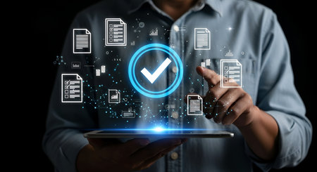 A person holds a tablet and touches a glowing digital interface featuring a large blue checkmark within a circle, signifying approval. Surrounding the checkmark are icons of documents and checklists, connected by a digital network. This visual represents digital verification and document management.の写真素材