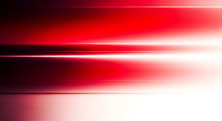 This abstract image presents horizontal streaks of light in shades of red and white, with a significant motion blur effect. The bright white light is central, radiating outwards into softer red tones and fading to dark at the edges. The texture is smooth and suggests rapid movement or energy.の写真素材