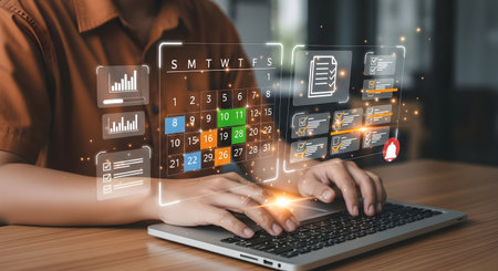 A person's hands are actively engaged with a digital interface projected above a laptop. The...