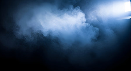 Dense, swirling clouds of blue and white smoke or fog fill the frame against a dark background. A...