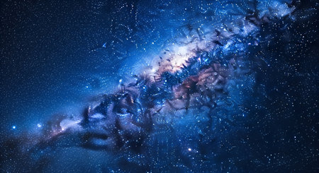 A breathtaking view of a vibrant blue nebula in the depths of space. Swirls of cosmic dust and gas create an ethereal, glowing cloud, illuminated by countless distant stars. The nebula's intricate patterns and deep blue hues evoke a sense of wonder and the vastness of the universe.の写真素材