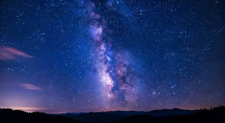 A stunning view of the Milky Way galaxy stretches across a deep blue night sky, filled with...