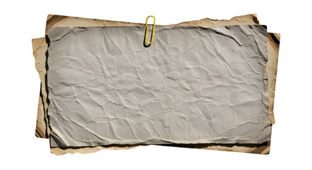 A stack of crumpled, aged paper sheets is held together by a single bright yellow paperclip. The...