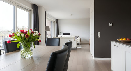 Modern dining room with tulip bouquet and city view. High resolution image suitable for commercial...