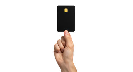 Banking showing hand holding black credit card with chip keywords: hand, holding, credit card, black card, chip, banking, finance, payment, money, transaction, technology, modern, isolated, white background, debit card, plastic card, financial, business, secure, access, data, information, thumb, finger, object description: a hand is holding a plain black credit card horizontally between the thumb and index finger. the card has a visible gold chip on the upper left corner. the...の写真素材