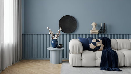 Modern living room with white sofa blue accents and minimalist decor