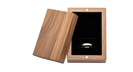 An open wooden box, designed for jewelry, is shown against a black background. The box has a natural...