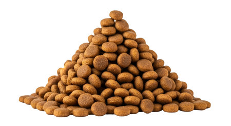 A close-up, high-angle shot of a large pile of dry dog food kibble. The kibble pieces are small,...