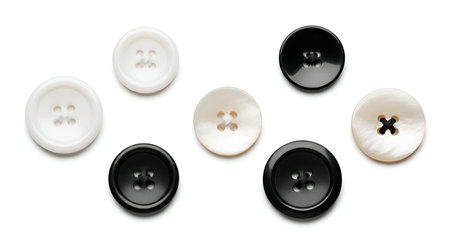 A collection of seven sewing buttons arranged on a clean white background. Three buttons are black...