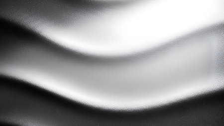 A close-up, abstract view of a smooth, silver metallic surface with flowing, wavy contours. Bright...