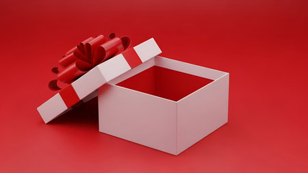 Image showing open white gift box with red bow on red background. High resolution image suitable for...