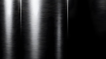 A dark, brushed metal surface with a distinct horizontal grain texture. Intense vertical streaks of...