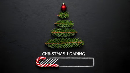 The a minimalist Christmas tree crafted from green pine branches arranged in a triangular shape on a dark background. At the of the tree is a red bauble, and below the tree is a white loading bar with a red and white striped candy cane as the progress indicator. The text "CHRISTMAS LOADING" is displayed above the loading bar, creating a festive and modern holiday-themed visual.の写真素材