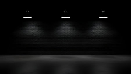 The a dark brick wall illuminated by three evenly spaced spotlights. The spotlights create distinct circular beams of light on the wall, casting strong shadows and creating a dramatic contrast between the illuminated areas and the surrounding darkness. The overall scene has a minimalist and theatrical mood, themes related to performances, presentations, or lightingの写真素材