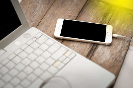 Close up phone on wooden table backgroundの写真素材