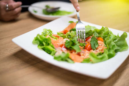Salmon Salad is on a plate placed on the tableの写真素材