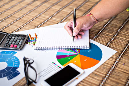 Woman writing idea for Analysis Business and financial report.の写真素材