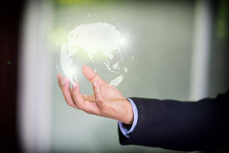 Global business concept with digital planet in handの写真素材