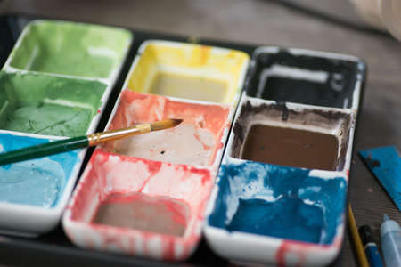 Photo of colorful and brush bright watercolor in cuvettesの写真素材
