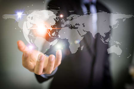 Businessman holding global network and data exchanges over the worldの写真素材