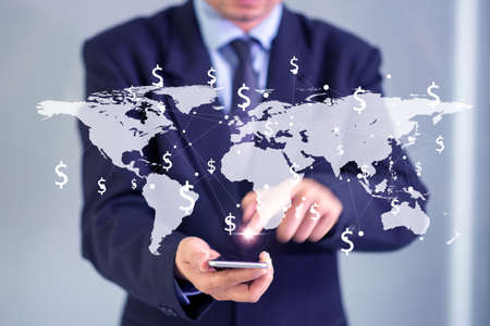businessman hand phone with world map on screen conceptの写真素材