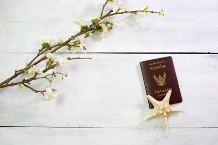 flowers and Passport on white wooden background. Flat lay, top viewの写真素材