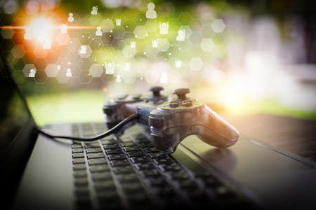 Video game controller isolated on the laptop conceptの写真素材