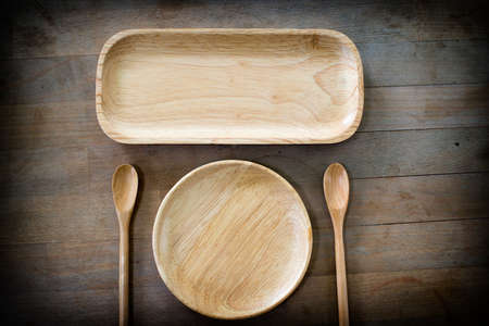 Wood dish and spoon on the wooden background. concept