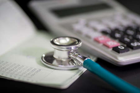 Finance accounting Medical treatment ,Stethoscope and calculator,book bank conceptの写真素材