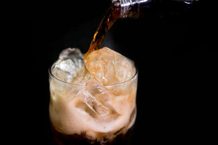 Cola pouring On The Black backgroundの写真素材
