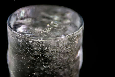 Splash of water on black, Stylish water splash. Isolated on black background, bubbles in the glass,conceptの写真素材