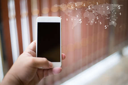Mockup image of hands holding white mobile phone is make money conceptの写真素材