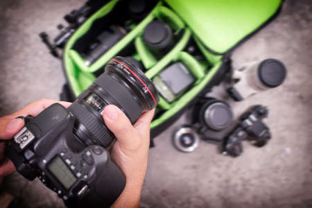 Photographer pack his camera and lenses to bagpack. Bag appliances for photography.