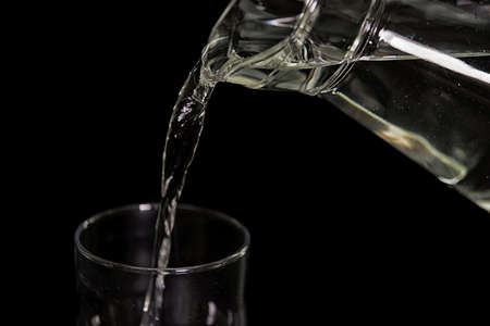 Water pouring On The Black backgroundの写真素材