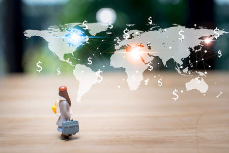 Travelling concepts male miniature mini figures with bag standing  go to make money in the worldの写真素材