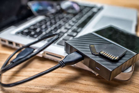 External Hard Disk and Memory Cards on Laptop Keyboard.High Dynamic Range tone