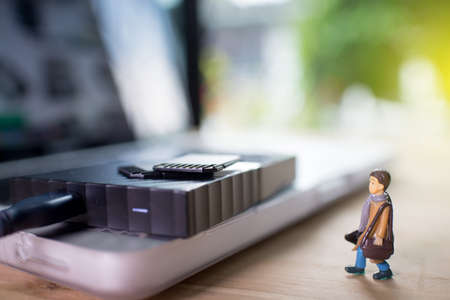 Technology concept,Miniature mini figures with bag go to repair storageの写真素材