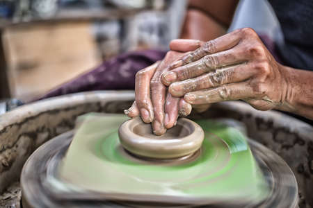 Hands working on pottery wheel High Dynamic Range toneの写真素材