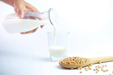 Isolated soy beans and soy milk in a glassの写真素材